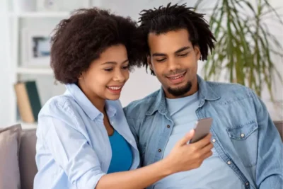 happy couple looking at something on their mobile