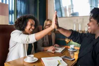 two ladies giving high fives
